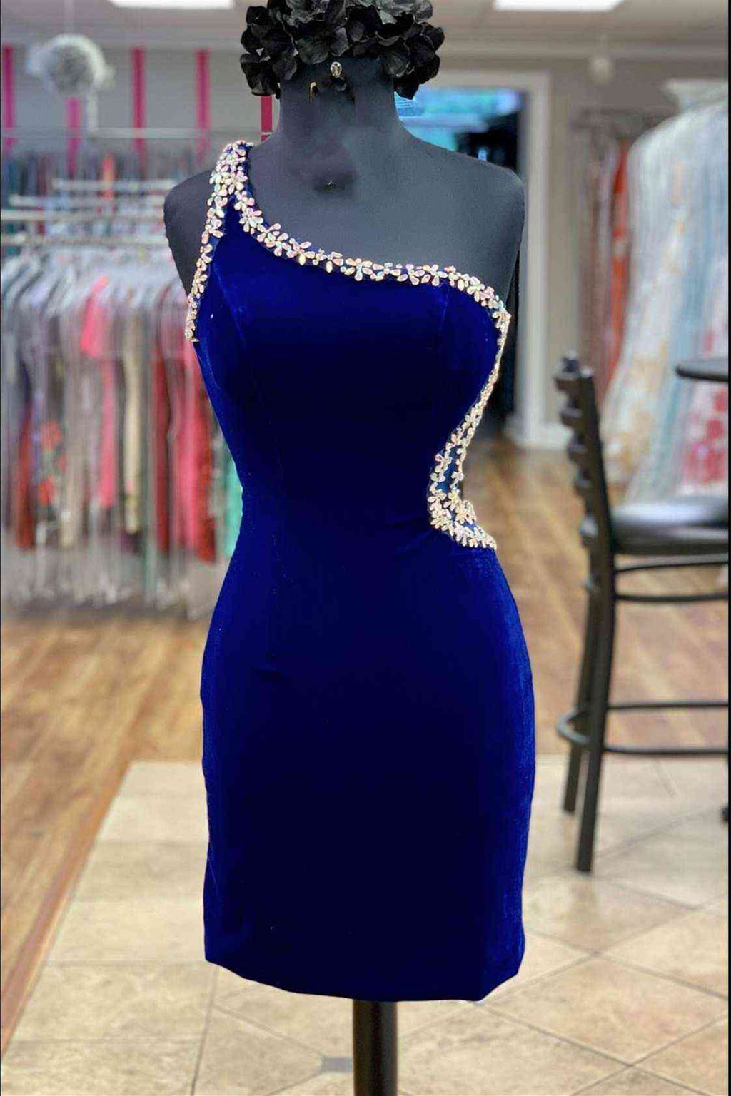 This tight short homecoming dress features hater neckline and sequins